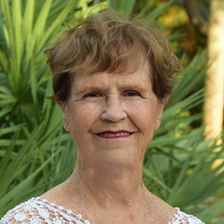 portrait of doctor nancy smith standing outside the jupiter counseling office and link to her biography page
